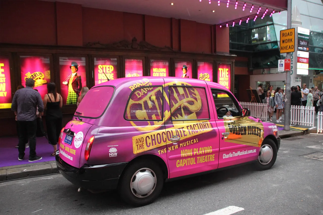 Adflow full taxi wrap for 'Charlie and the Chocolate Factory' musical (Capitol Theatre, Sydney) on a London-style cab, NSW Government sponsor