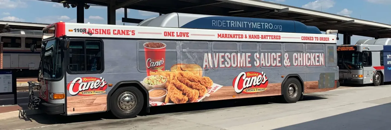 Raising Cane's full-side transit bus wrap on a Trinity Metro (Fort Worth) bus, by Adsposure