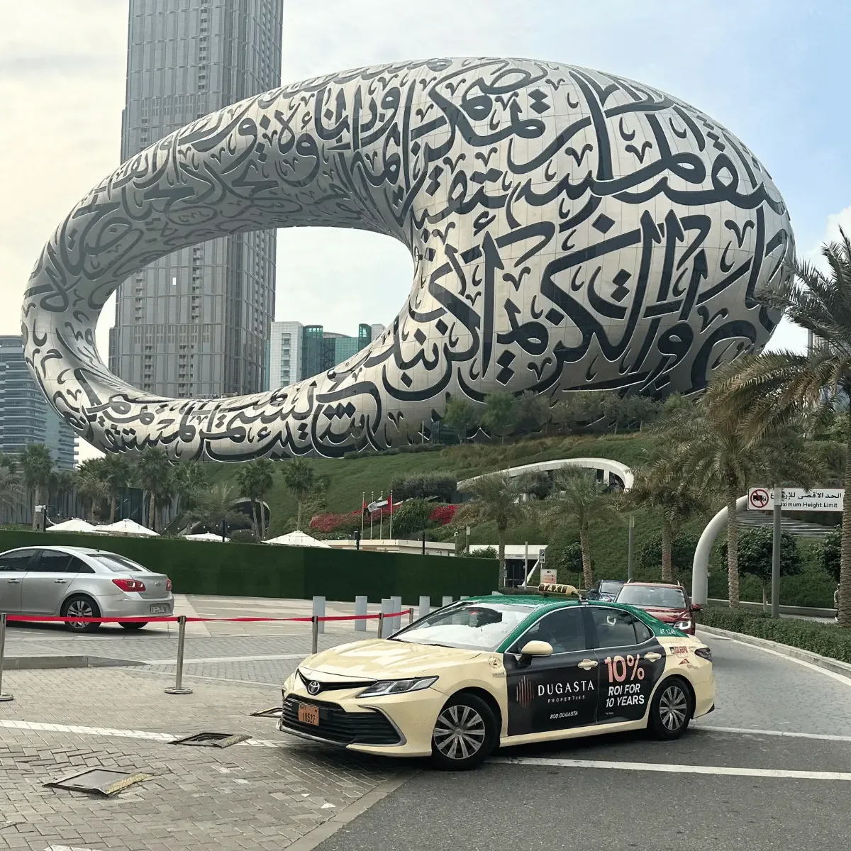Branded Dubai taxi driving past the Museum of the Future