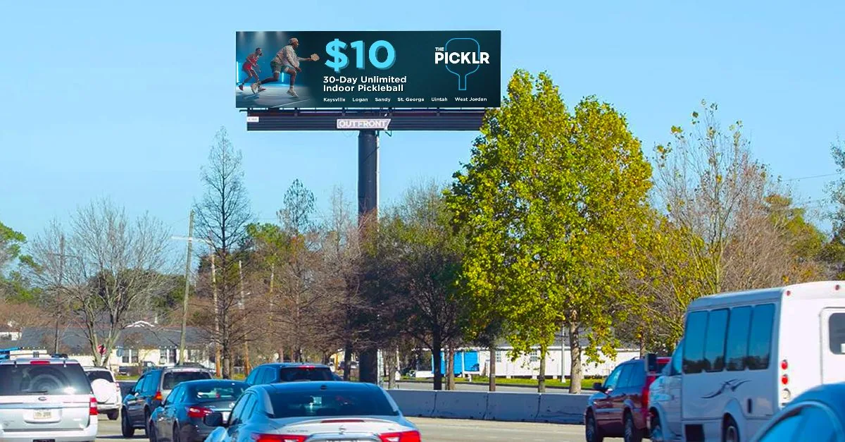 The Picklr '$10 30-Day Unlimited Indoor Pickleball' ad live on an OUTFRONT highway digital billboard, run via Blip Billboards.