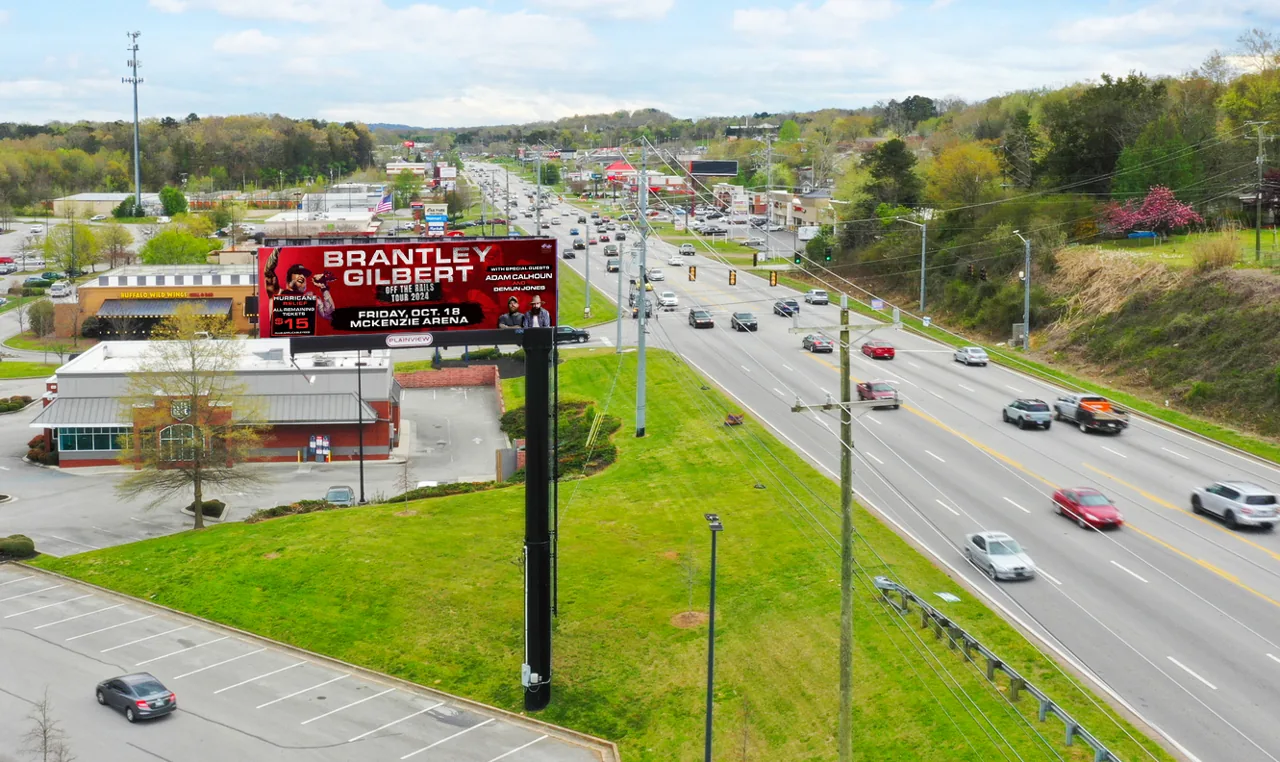 Pepper Entertainment 'Brantley Gilbert Off The Rails Tour' concert ad on a Plainview roadside digital billboard (aerial photo), booked through Blip Billboards.