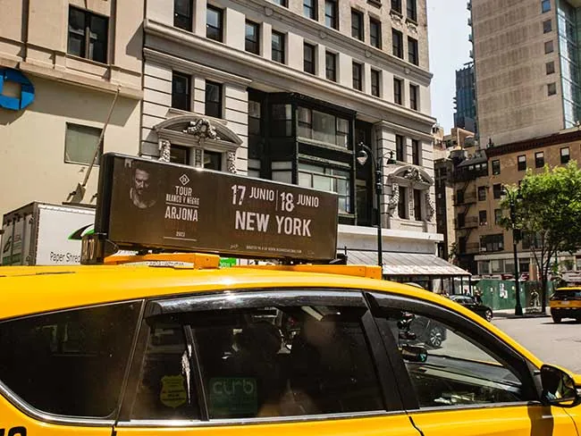 Loud & Live 'Ricardo Arjona' tour digital taxi-top display on a New York City yellow cab, placed via Blue Line Media