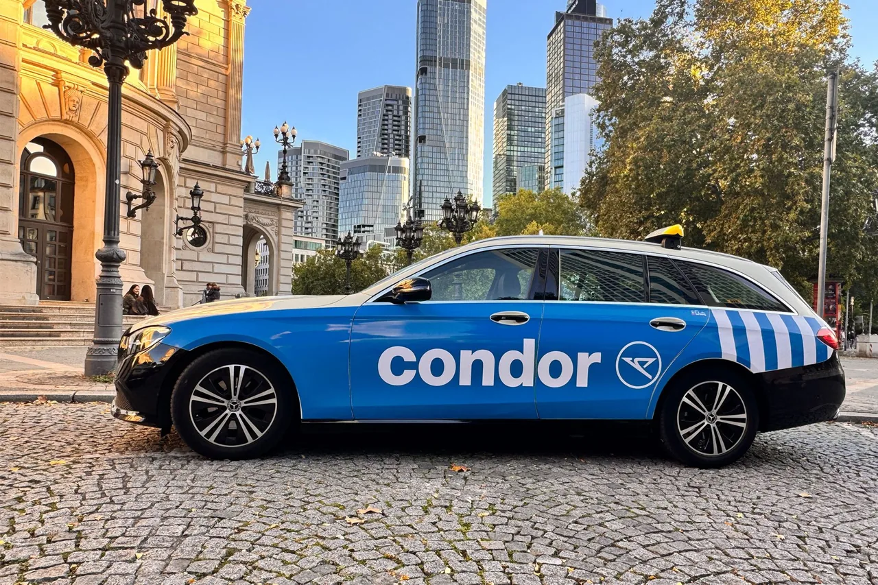 Condor airline full-vehicle taxi wrap (blue livery) parked by the Alte Oper, Frankfurt