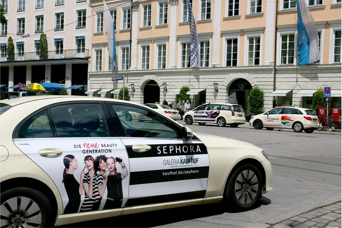 Sephora / Galeria Kaufhof 'Die neue Beauty Generation' door-cover ad on a taxi in Munich (cabvertising logo visible)