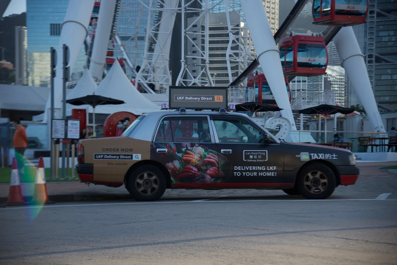 Digital taxi-top LED display running an ad on a Hong Kong taxi