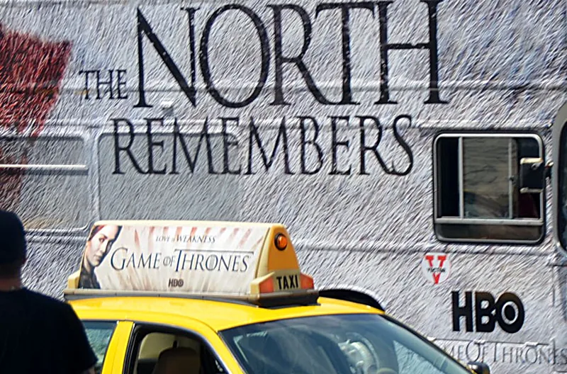 HBO Game of Thrones 'The North Remembers' taxi-top crown on a NYC-style yellow cab, alongside a large building wall wrap (Comic-Con activation) — from CVA's Game of Thrones case study