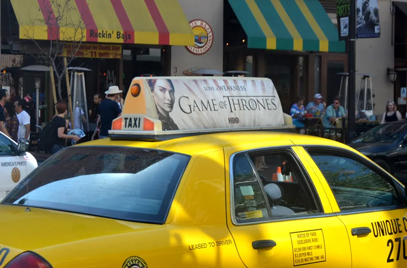 HBO Game of Thrones 'Love is Weakness' illuminated taxi-top on a yellow cab at a Comic-Con street scene — CVA Game of Thrones case study