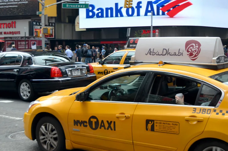 Abu Dhabi Tourism taxi-top on an NYC yellow cab in Times Square (Bank of America backdrop) — CVA Abu Dhabi case study