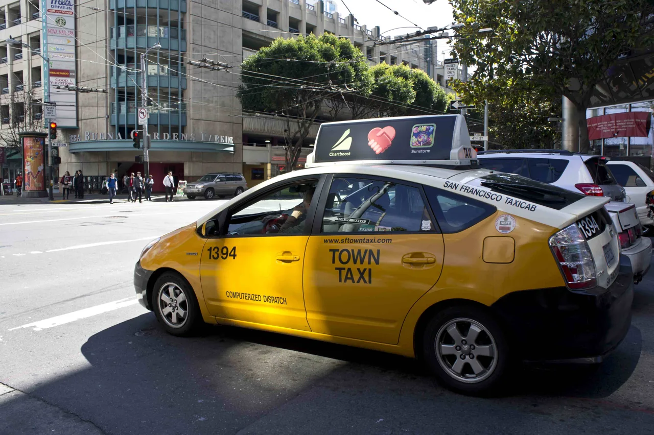 Digital LED taxi-top screen (Chartboost / Candy Crush / Sunstorm rotation) on a San Francisco Town Taxi at Yerba Buena — CVA taxi advertising markets page