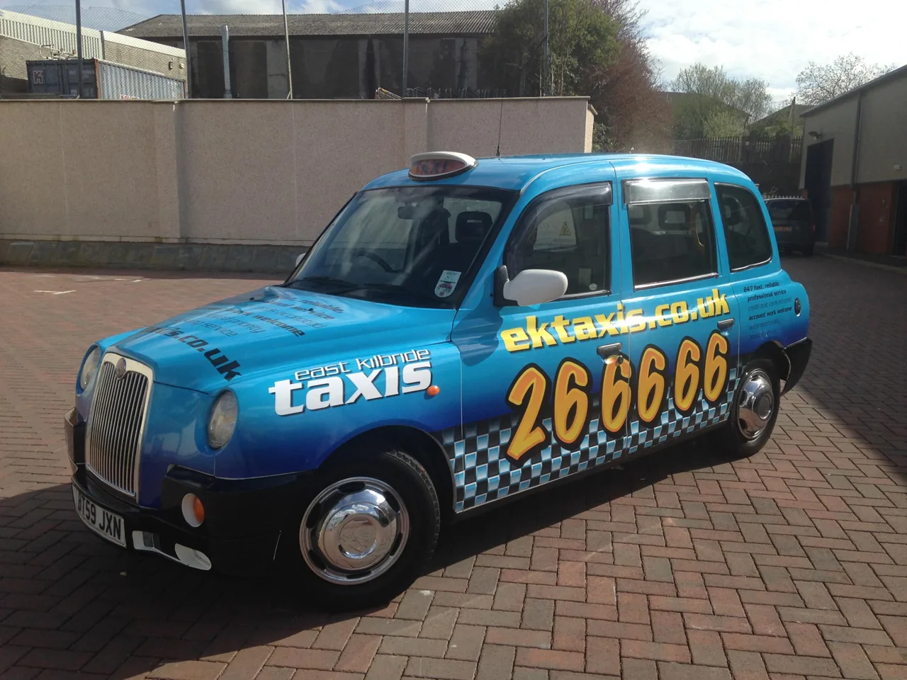 East Kilbride Taxis (ektaxis.co.uk) blue full taxi wrap on a Hackney cab, from Clyde Wraps' taxi advertising page.