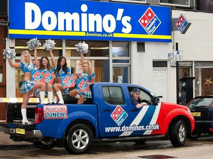 Domino's Pizza "Let's do Lunch" wrap on a Nissan Navara pickup, shown in Clyde Wraps' homepage gallery.