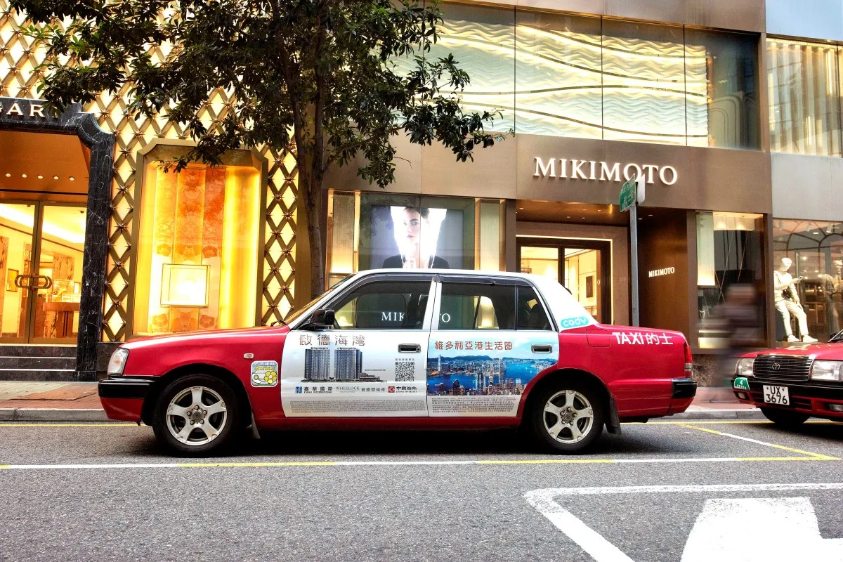 Wheelock property development Hong Kong taxi wrap (4-door format) on a red urban taxi outside Mikimoto, CODY-branded