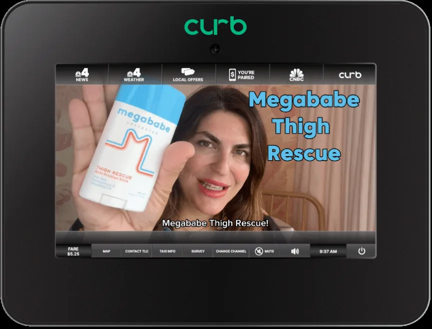 Product render of the Curb Taxi TV in-cab screen showing the live TaxiTV interface (news/weather/local offers tabs, fare and menu bar) running a real Megababe 'Thigh Rescue' advertiser video ad.