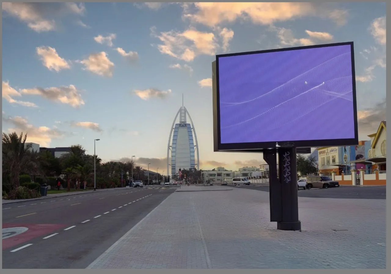 Roadside DOOH digital billboard screen on a Dubai street with the Burj Al Arab in the backdrop