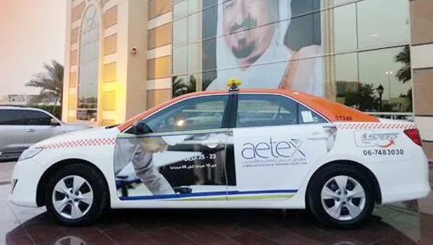 Taxi wrap advertising on a Sharjah taxi (EDS)