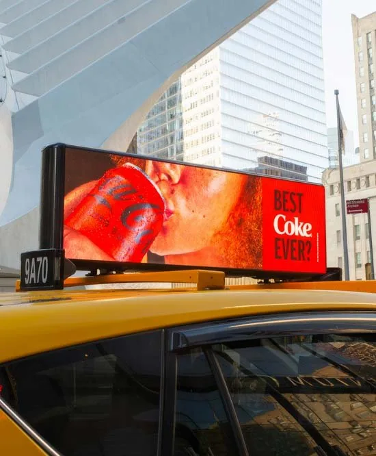 Firefly digital taxi rooftop screen running a Coca-Cola campaign