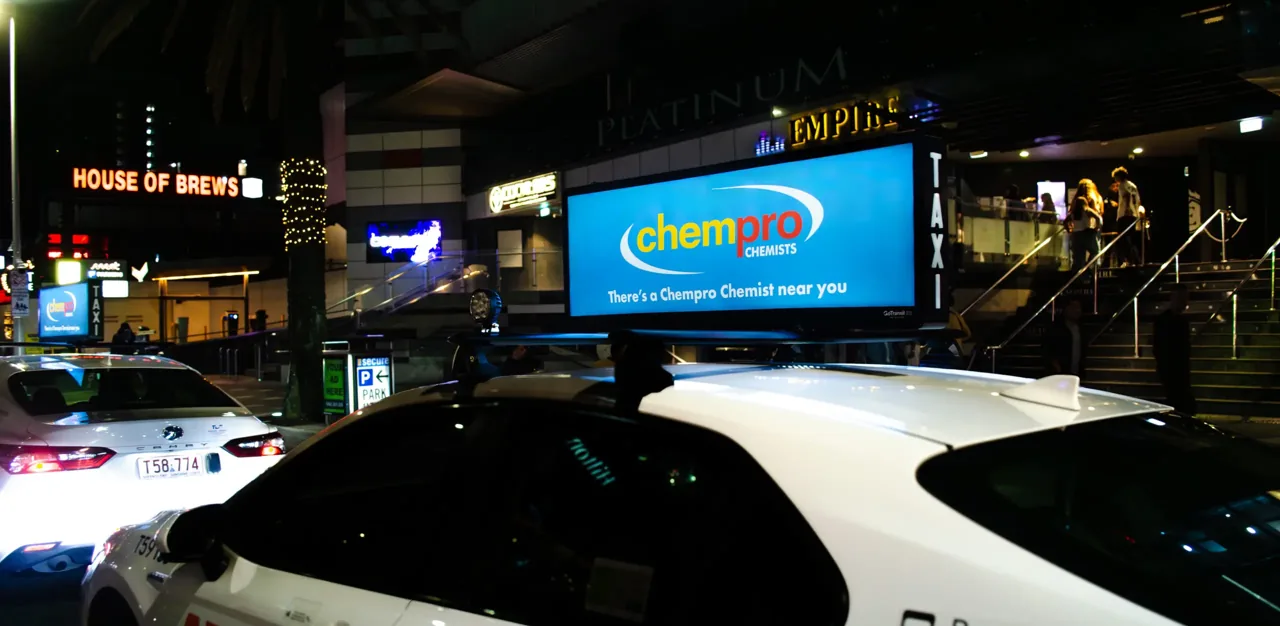 Chempro Chemist illuminated taxi-top sign in a nightlife precinct (GoTransit Media Group)