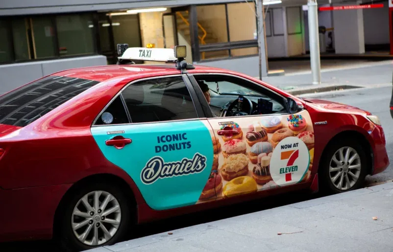 Daniel's Donuts branded sedan taxi wrap (GoTransit Media Group)