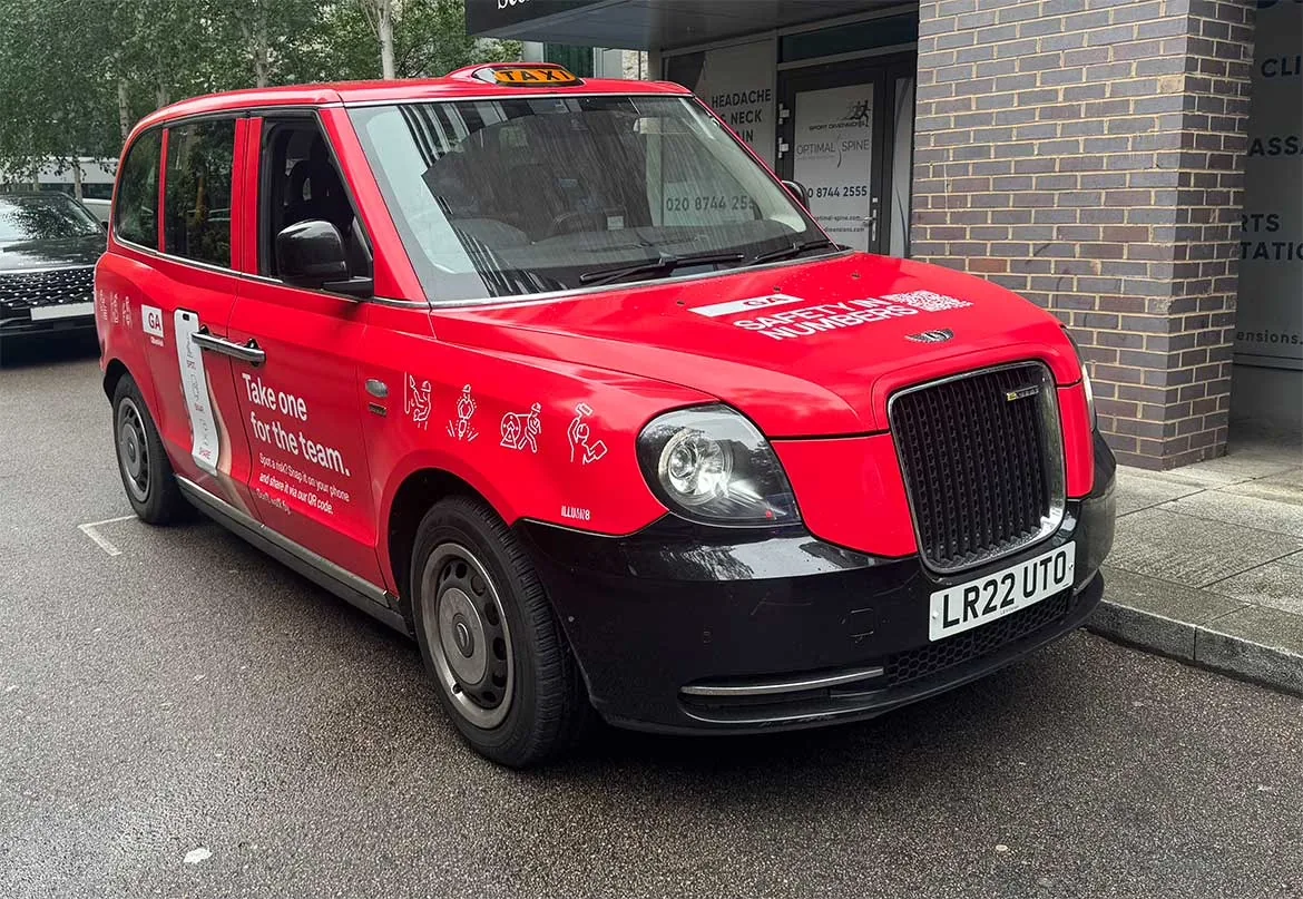 'Safety in Numbers - Take one for the team' full red cab wrap, ILLUMIN8 branding on door (London LEVC taxi)