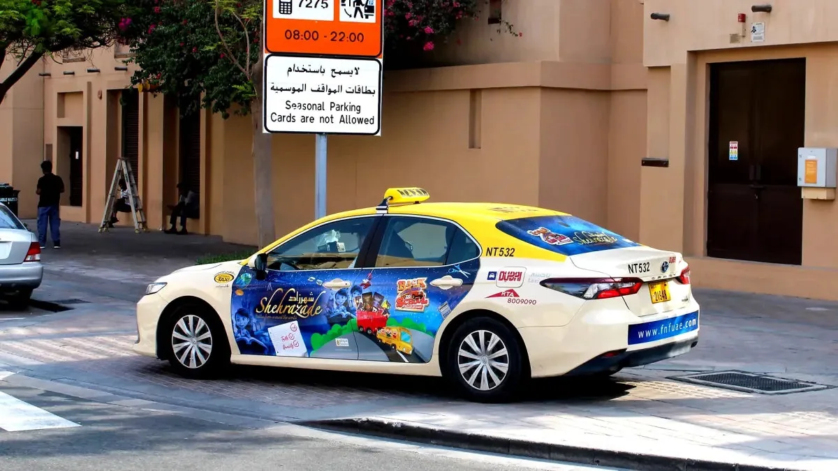 Shehrazade / FnF full-body wrap on a yellow Dubai RTA taxi (marketplace listing photo)