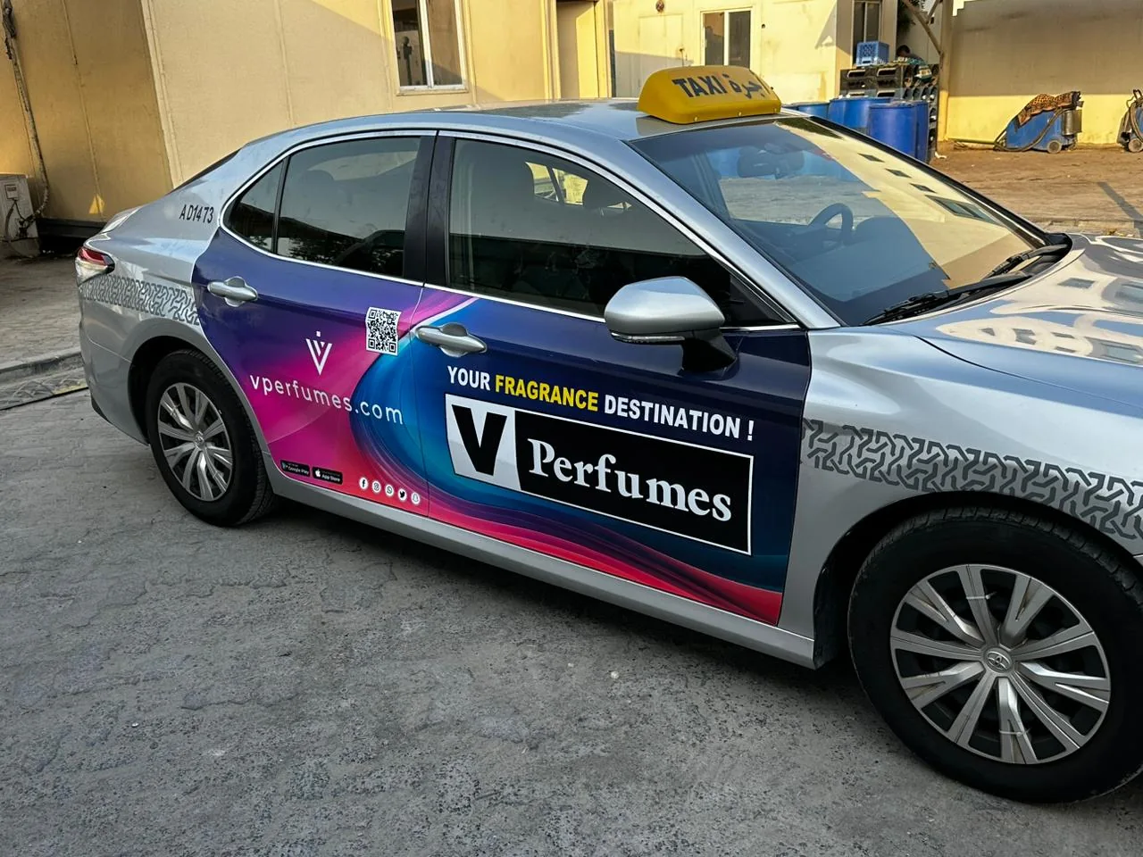V Perfumes full-body wrap on a silver Abu Dhabi taxi (marketplace listing photo)