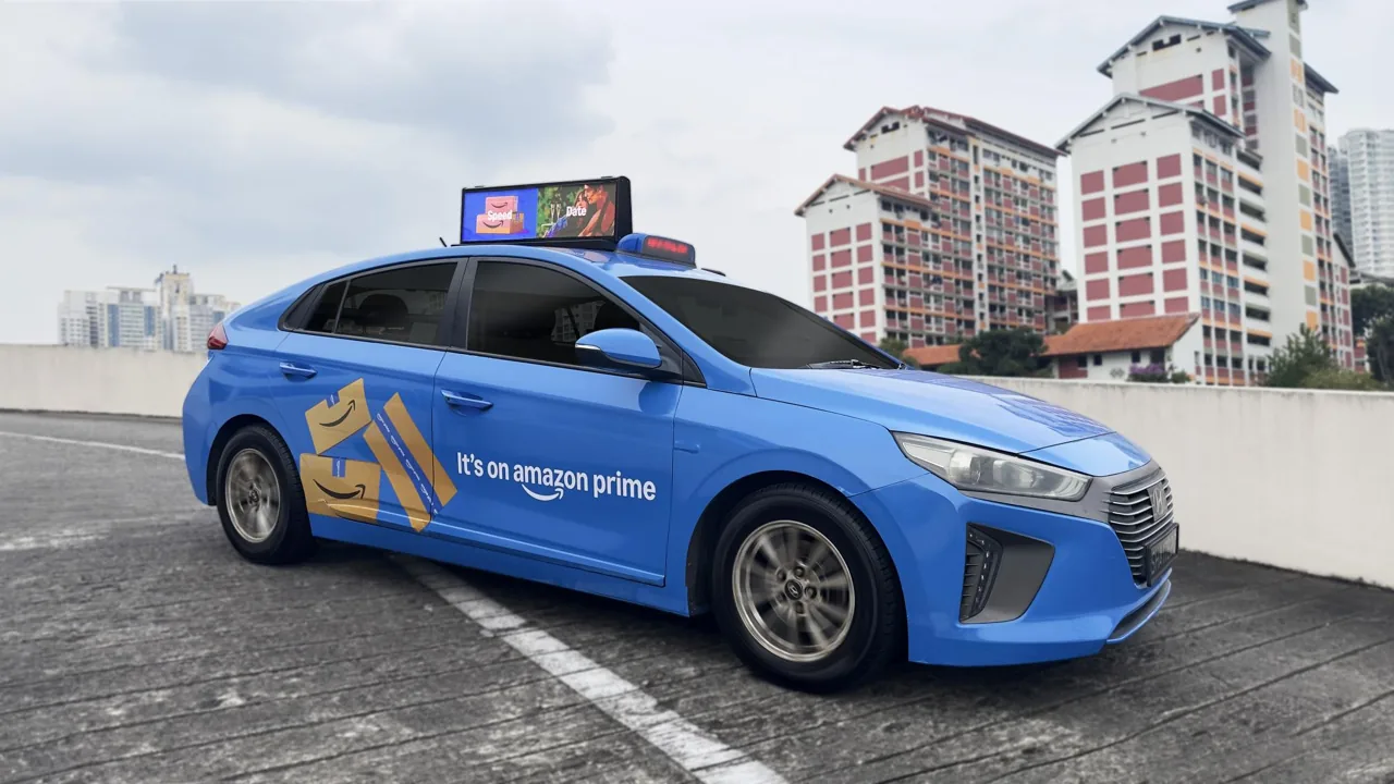 Moove Media 'Dynamic Cab' digital taxi-top billboard on a ComfortDelGro taxi in Singapore, running Amazon Prime creative (first client) — photo from parent-company ComfortDelGro press release.