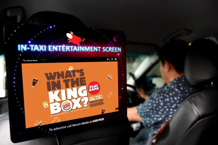 Moove Media in-taxi entertainment screen (rear headrest display) running an interactive Burger King 'What's in the King Box?' campaign — photo from Campaign Asia.