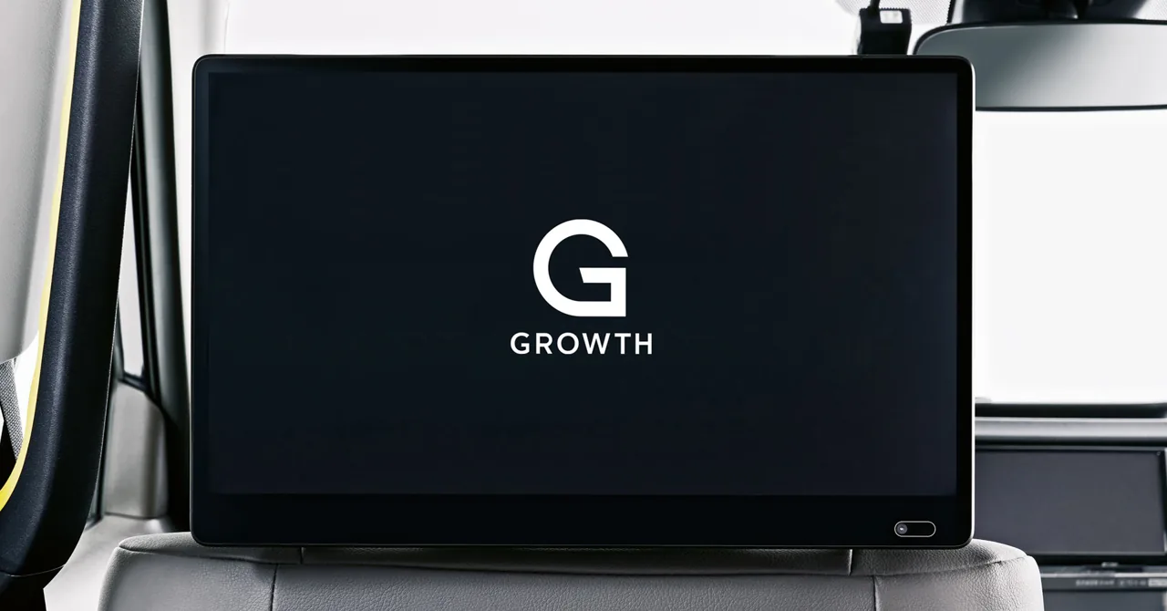 GROWTH in-taxi digital signage tablet mounted on the back of a taxi front seat, showing the GROWTH logo