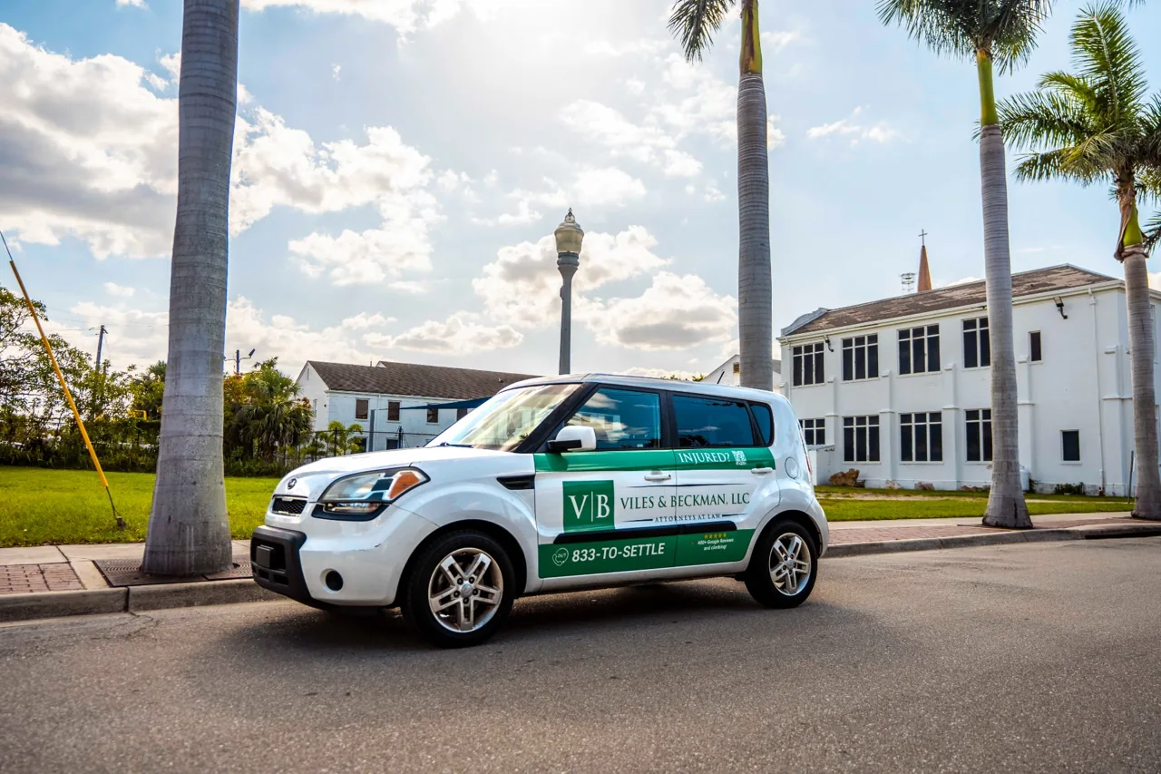 Viles & Beckman, LLC partial car wrap on a white Kia Soul (Florida) - Nickelytics rideshare wrap campaign