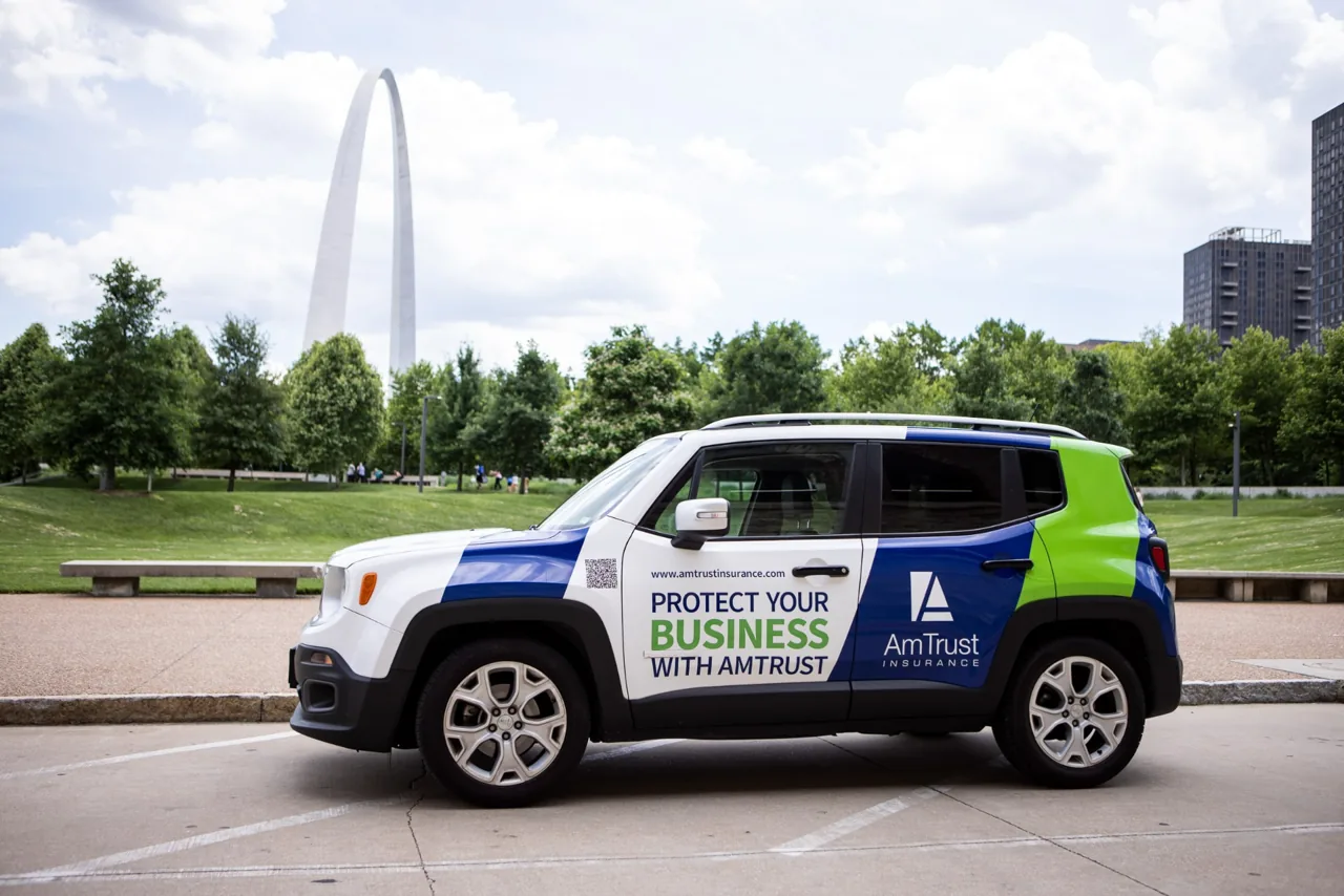 AmTrust Insurance full vehicle wrap on a Jeep Renegade at the St. Louis Gateway Arch - Nickelytics brand car-wrap campaign