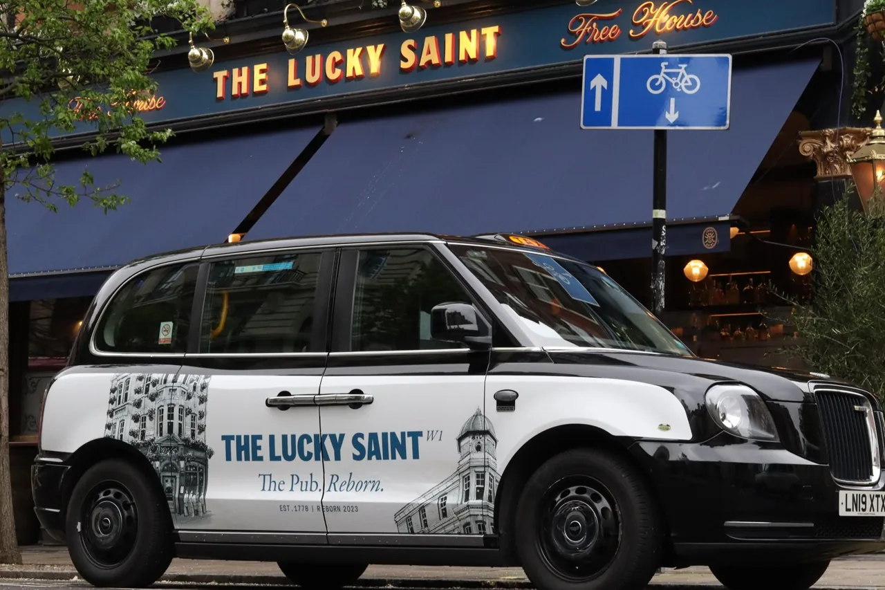 The Lucky Saint 'The Pub. Reborn.' full wrap on a London black cab, One Day agency taxi advertising