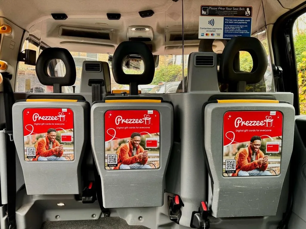 Prezzee digital gift cards ads on taxi interior seat-back tip-seat panels, One Day agency taxi interior advertising