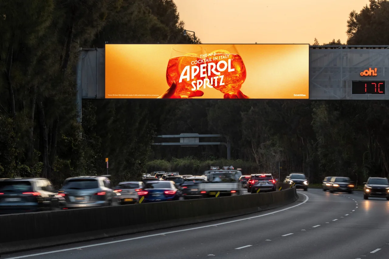 Aperol Spritz on an oOh!media digital motorway gantry billboard with live temperature display