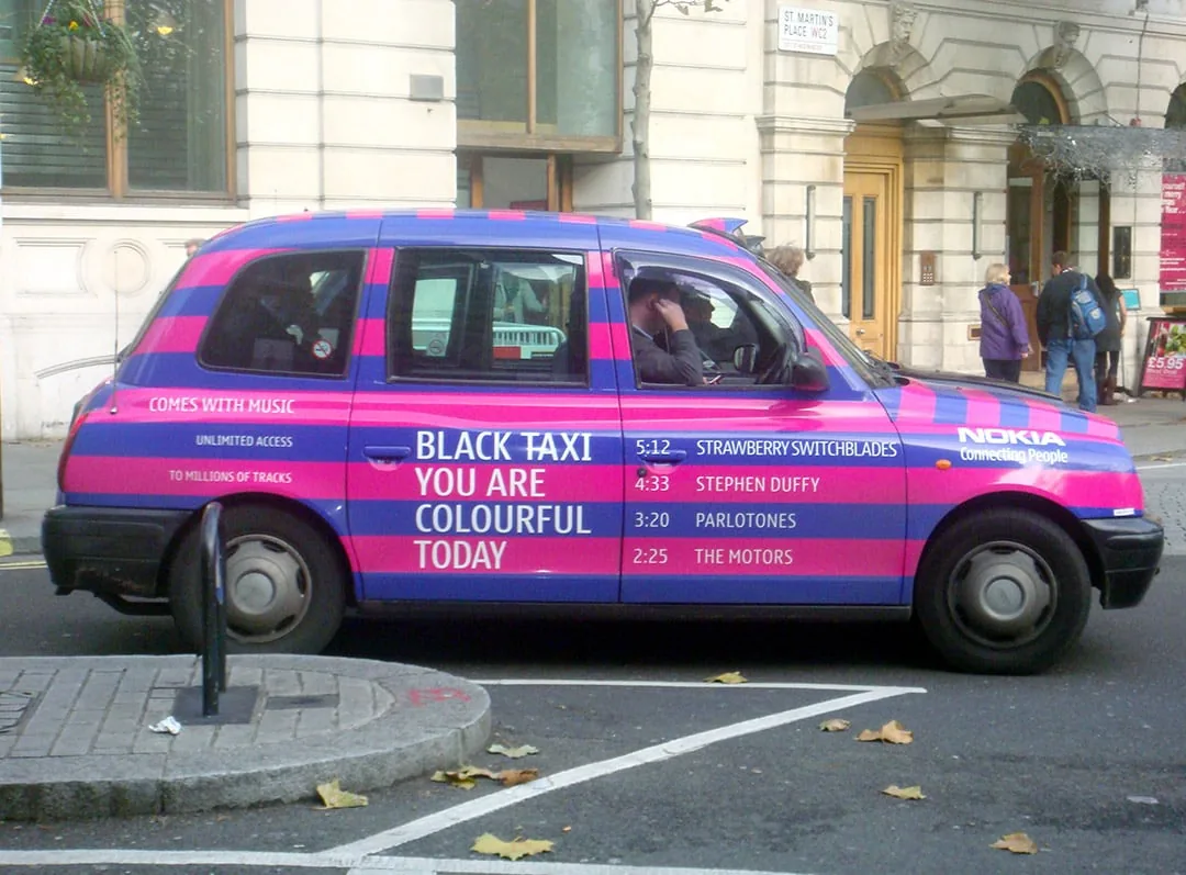 Full-wrap pink/blue London taxi for Nokia 'Comes With Music - Black Taxi You Are Colourful Today' campaign