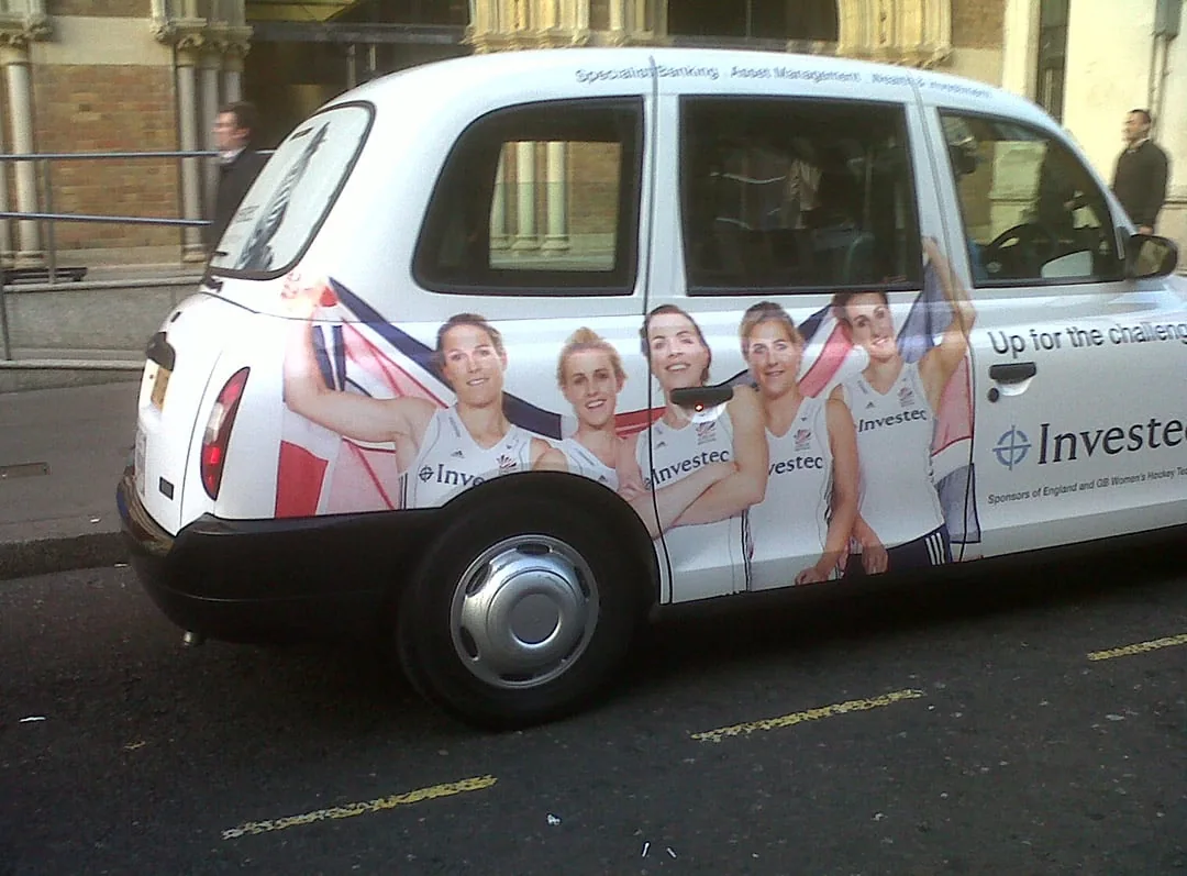 Full-wrap white London black cab for Investec 'Up for the challenge' (GB Women's Hockey sponsorship)