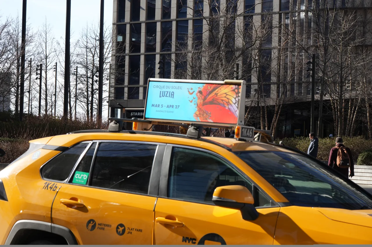 Cirque du Soleil creative on a digital taxi-top display atop a NYC yellow cab