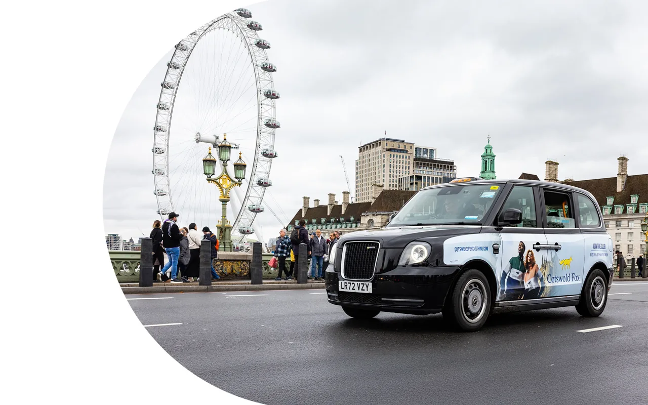 Cotswold Fox 'Join the Club' superside taxi livery crossing Westminster Bridge by the London Eye