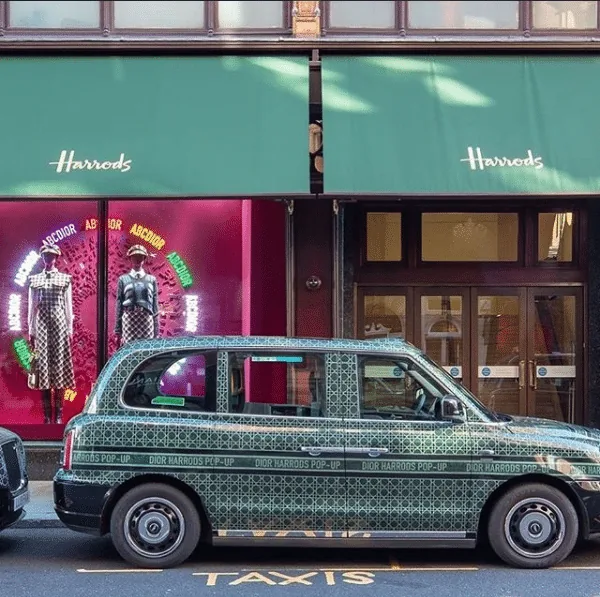 Dior Harrods pop-up branded electric taxi parked outside Harrods