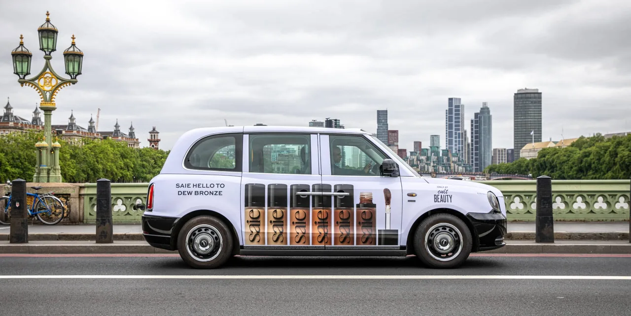 Cult Beauty x Saie 'Dew Bronze' full taxi wrap on Westminster Bridge