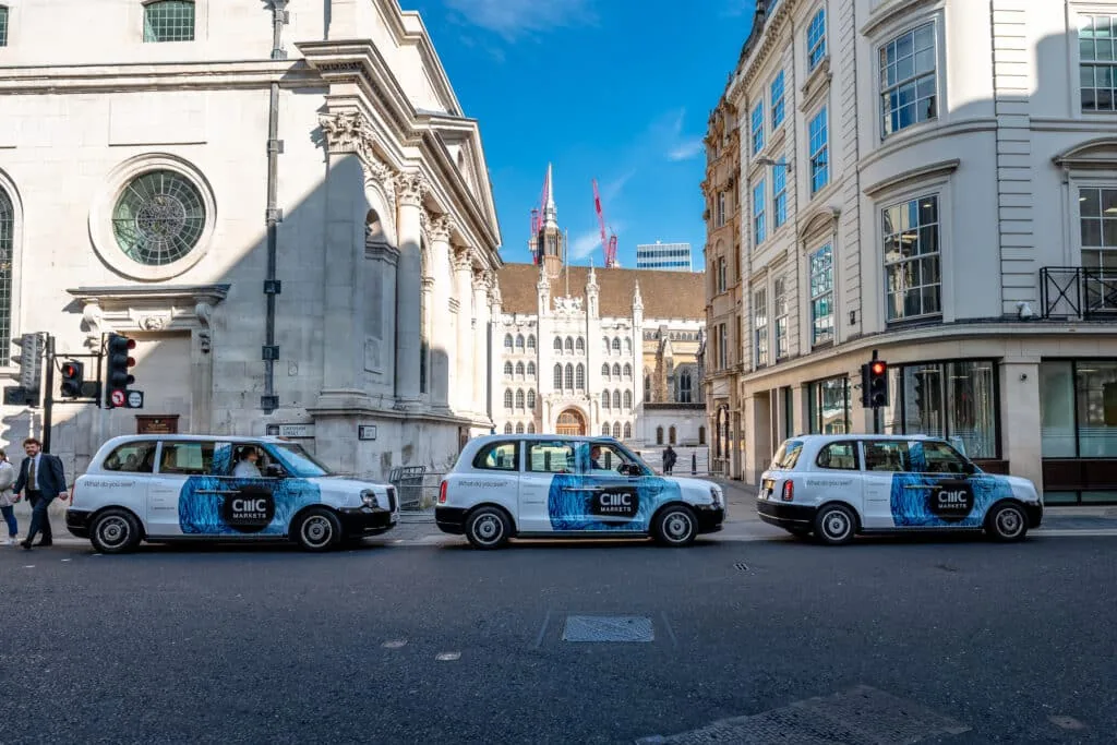 CMC Markets multi-taxi wrapped fleet lined up by Guildhall in the City of London