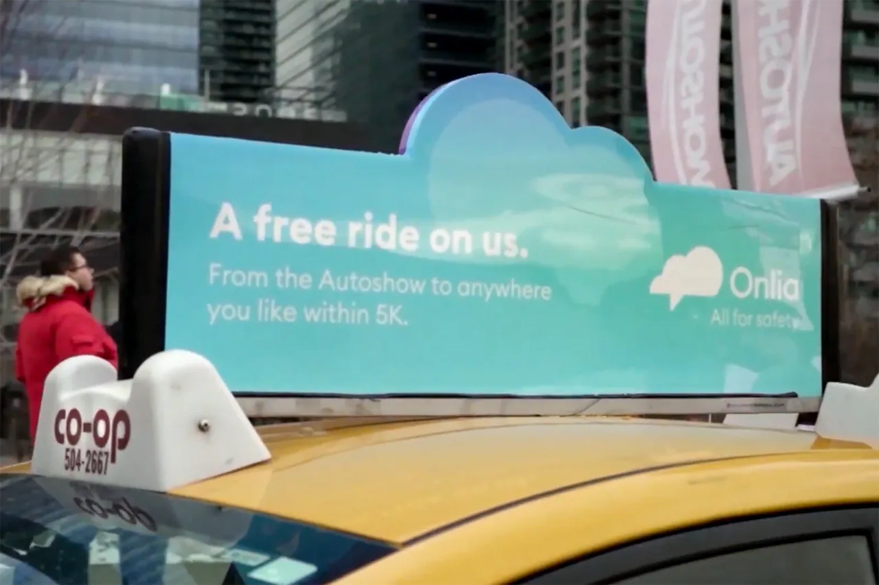 Onlia 'A free ride on us' digital taxi-top display on a Co-op taxi at the Auto Show (Statements Media)