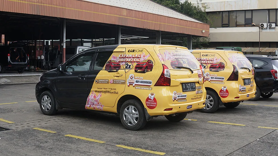 Carsome yellow half-wrap car branding on a fleet of MPVs (StickEarn StickMob half wrap) — StickEarn's own showcase gallery.