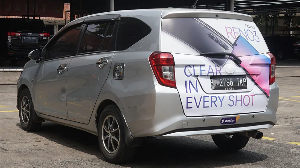 OPPO Reno3 'Clear In Every Shot' partial back-panel car sticker on a silver MPV (StickEarn StickMob) — StickEarn's own showcase gallery.