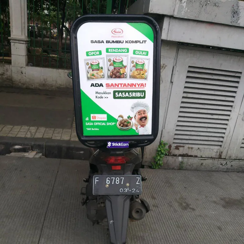 Sasa 'Bumbu Komplit' seat-back advertising box mounted on a motorcycle (StickEarn StickMotor) — StickEarn's own showcase gallery.
