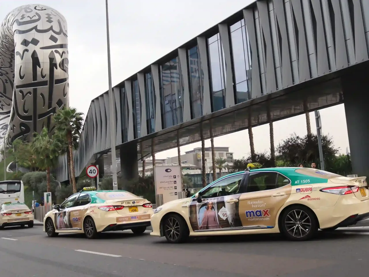 Branded taxi campaign photographed near Burj Khalifa, Dubai, Synergy Arabia portfolio