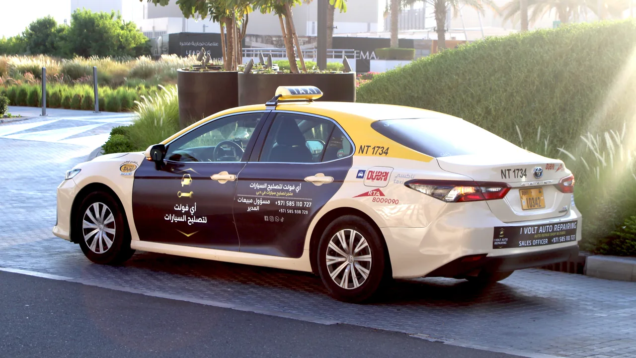 iVolt Auto exterior wrap on a Dubai RTA taxi (Taxi Advertising)