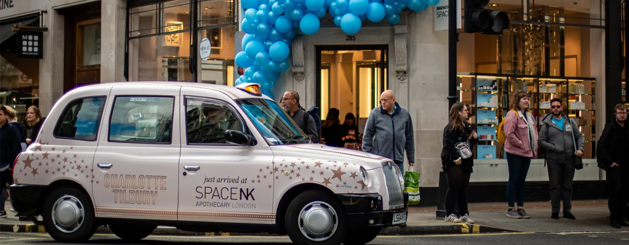 Space NK / Charlotte Tilbury full-livery London black-cab taxi wrap outside a store activation (The Ark Marketing & Media own work)