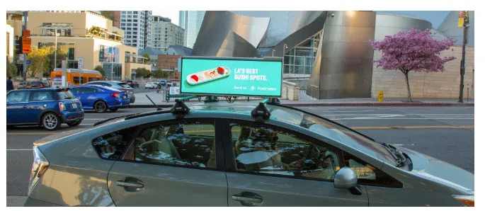 Uber OOH two-sided digital cartop screen on a vehicle running an Uber Eats food-delivery ad (via OOH Today)