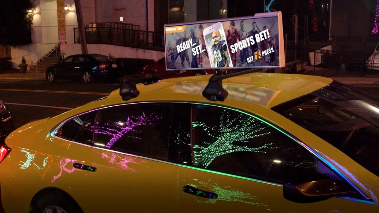 Uber OOH digital top-screen shown adorning New York City yellow cabs (via Adweek); press image, may be a promotional composite