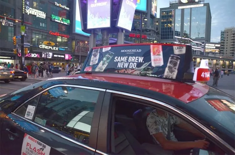 Moosehead Breweries static taxi-top ad on a traditional Toronto taxi (Wild On Media)